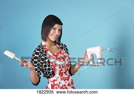 A woman holding a hand mixer View Large Photo Image Stock Photography - A woman holding a hand mixer. Fotosearch