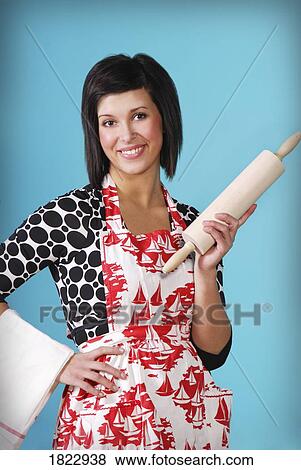Stock Photo - A woman holding a rolling pin. Fotosearch