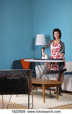 Stock Photo - A woman ironing. Fotosearch