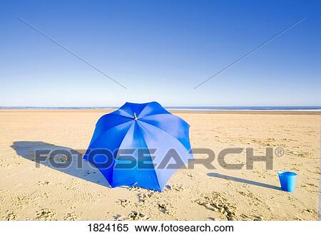 An umbrella and a pail on the beach View Large Photo Image Stock Photography - An umbrella and a pail on the beach. Fotosearch