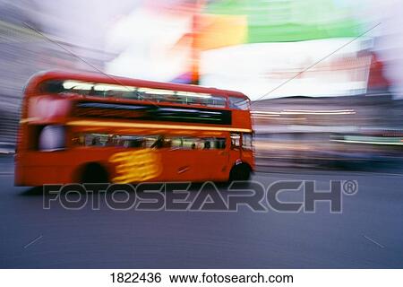 Stock Photograph - Blurred motion of double-decker bus, Piccadilly Circus, London, England. Fotosearch