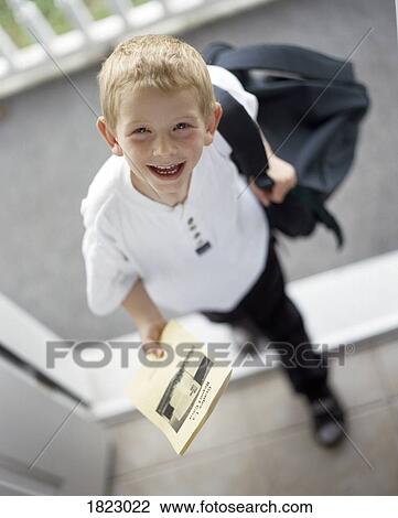 Stock Image - Boy coming home from school. Fotosearch