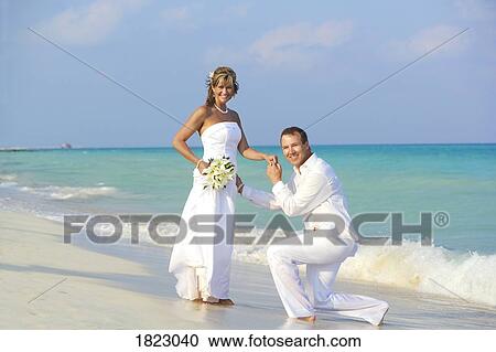Bride and groom on the beach View Large Photo Image Stock Image - Bride and groom on the beach. Fotosearch