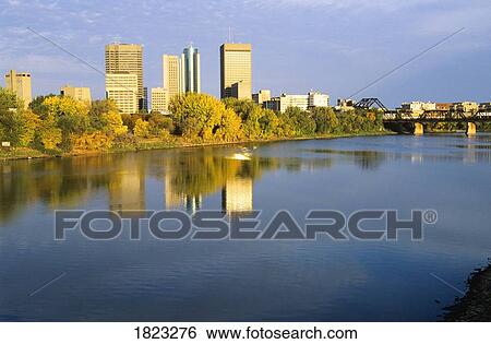 Stock Photograph - Buildings in Downtown Winnipeg reflected in the Red River, Manitoba, Canada. Fotosearch