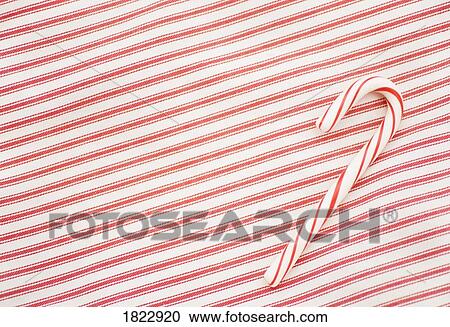 Stock Image - Candy cane on a red & white background. Fotosearch