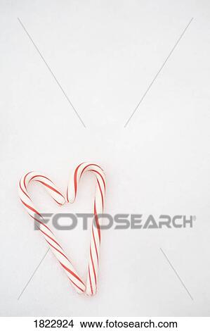 Picture - Candy canes forming a heart. Fotosearch