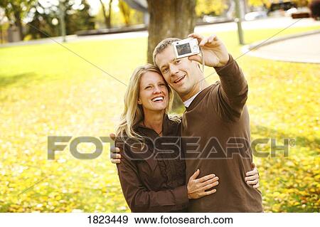 Couple taking a picture of themselves View Large Photo Image Stock Photo - Couple taking a picture of themselves. Fotosearch