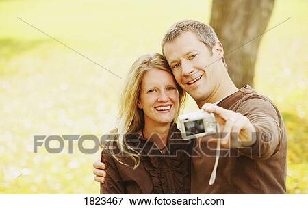 Couple taking picture of themselves View Large Photo Image Stock Photo - Couple taking picture of themselves. Fotosearch