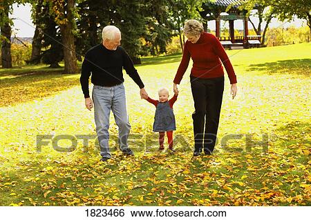 Stock Photograph - Couple walking with little girl. Fotosearch