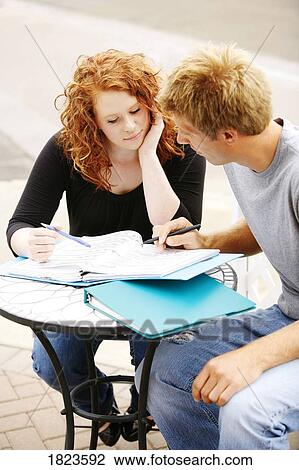 Couple working on homework View Large Photo Image Stock Image - Couple working on homework. Fotosearch