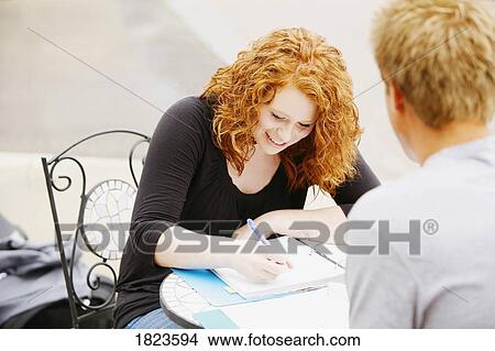 Couple working on homework together View Large Photo Image Picture - Couple working on homework together. Fotosearch