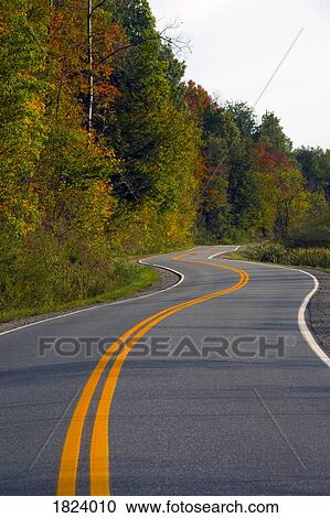 Stock Image - Fall colour and country road . Fotosearch