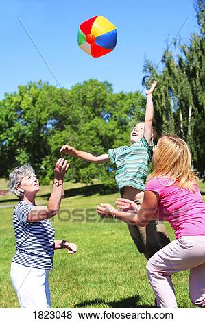 Family playing with a ball View Large Photo Image Stock Photo - Family playing with a ball. Fotosearch