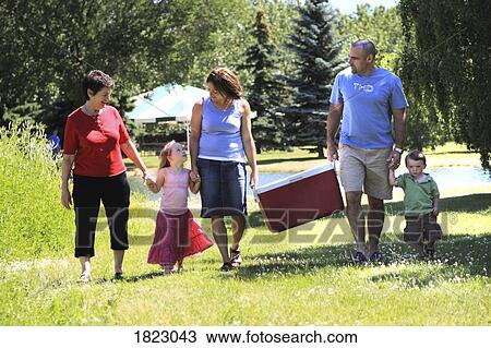 Family walking in the park View Large Photo Image Stock Image - Family walking in the park. Fotosearch