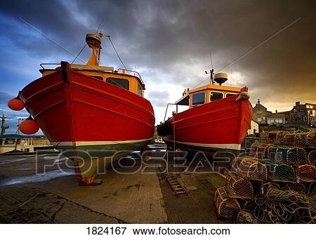 Stock Photo - Fishing boats out of the water for winter, Northumberland, England. Fotosearch