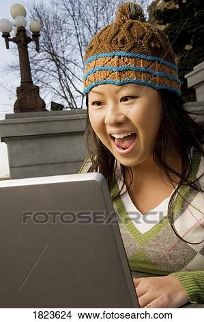 Girl excited about what she sees on computer View Large Photo Image Picture - Girl excited about what she sees on computer. Fotosearch