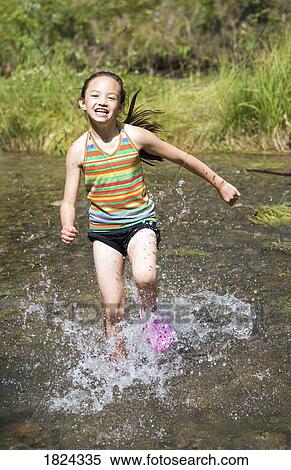 Stock Photography - Girl running through water . Fotosearch