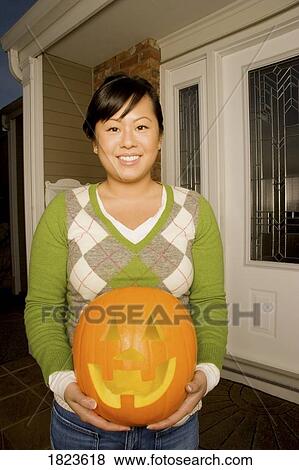 Girl with pumpkin View Large Photo Image Stock Photo - Girl with pumpkin. Fotosearch