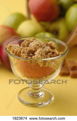 Granola on an apple View Large Photo Image Picture - Granola on an apple. Fotosearch