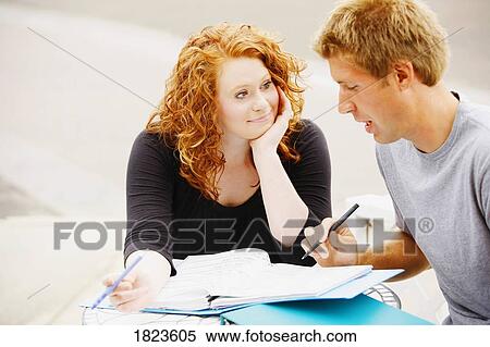 Stock Photography - Man and woman studying together. Fotosearch