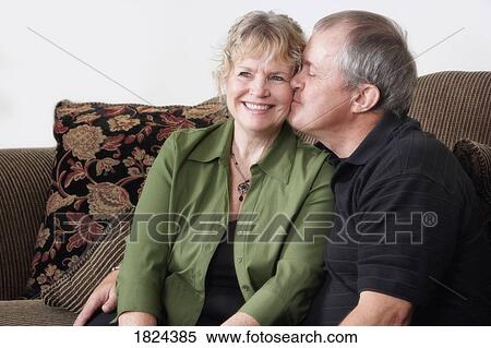 Stock Photography - Man kissing cheek of woman. Fotosearch