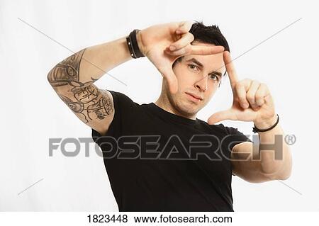 Man making a "finger frame" View Large Photo Image Stock Photo - Man making a "finger frame". Fotosearch