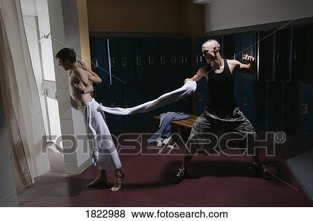 Man snapping towel at other man in the locker room View Large Photo Image Stock Photo - Man snapping towel at other man in the locker room. Fotosearch