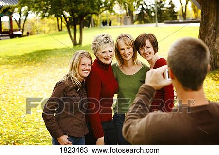Man taking photograph of women View Large Photo Image Stock Image - Man taking photograph of women. Fotosearch