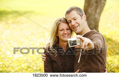 Man taking picture of himself and wife View Large Photo Image Stock Image - Man taking picture of himself and wife. Fotosearch