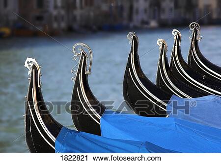 Moored gondolas in a row, Venice, Italy View Large Photo Image Stock Image - Moored gondolas in a row, Venice, Italy. Fotosearch