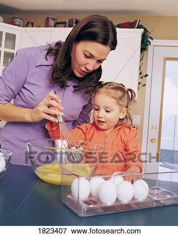 Mother and child in the kitchen View Large Photo Image Stock Photo - Mother and child in the kitchen. Fotosearch