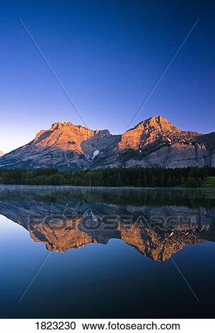 Stock Image - Mount Kidd reflected in Wedge Pond, Kananaskis Country, Alberta, Canada. Fotosearch