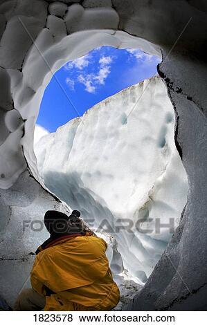 Photographer in an ice cave View Large Photo Image Stock Photo - Photographer in an ice cave. Fotosearch