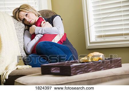 Stock Photo - Sad woman sitting alone. Fotosearch
