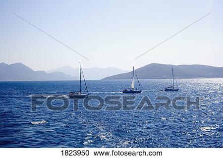 Stock Image - Sailboats on the Aegean Sea, Greece. Fotosearch