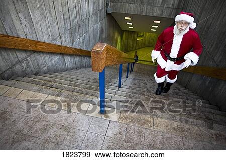 Stock Photo - Santa coming up the stairs. Fotosearch