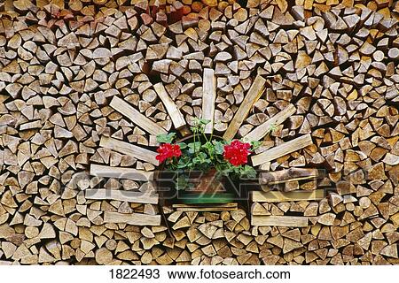 Stock Image - Stack of wood with flower pot. Fotosearch