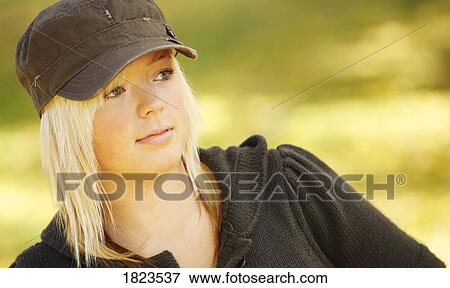 Teenage girl in a hat View Large Photo Image Stock Photo - Teenage girl in a hat. Fotosearch