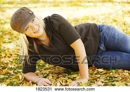 Teenage girl lying on the ground View Large Photo Image Stock Image - Teenage girl lying on the ground. Fotosearch