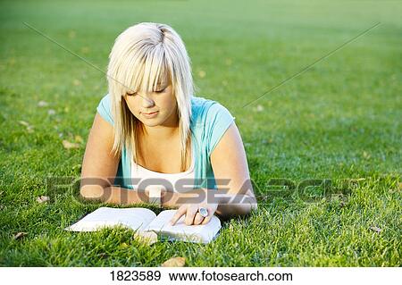 Teenage girl reading her Bible View Large Photo Image Stock Photo - Teenage girl reading her Bible. Fotosearch