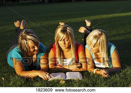 Three girls reading the Bible View Large Photo Image Stock Photo - Three girls reading the Bible. Fotosearch