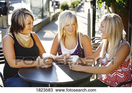 Stock Image - Three girls sitting together. Fotosearch