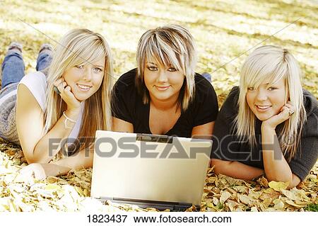 Stock Photo - Three girls with a computer. Fotosearch