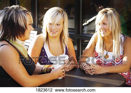 Three teens at a cafe View Large Photo Image Stock Image - Three teens at a cafe. Fotosearch