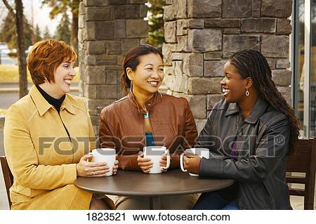 Stock Image - Three women visiting. Fotosearch