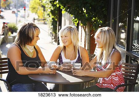 Stock Image - Three young girls talking together. Fotosearch