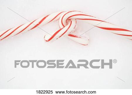 Stock Photography - Two candy canes in the snow. Fotosearch