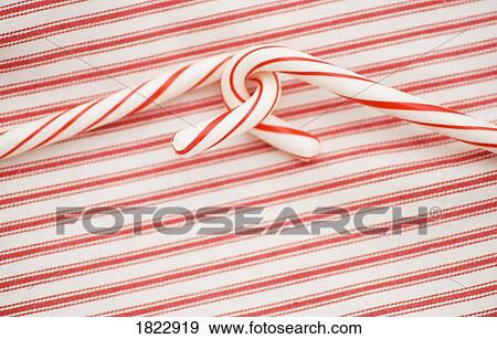 Two candy canes on a red and white background View Large Photo Image Stock Photo - Two candy canes on a red and white background. Fotosearch