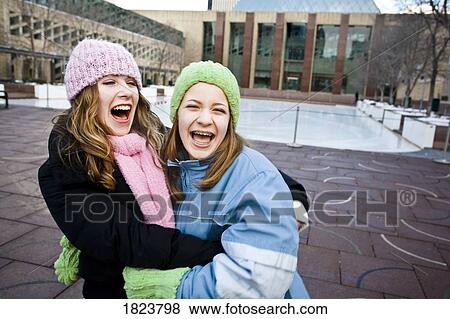 Stock Photo - Two friends laughing together. Fotosearch