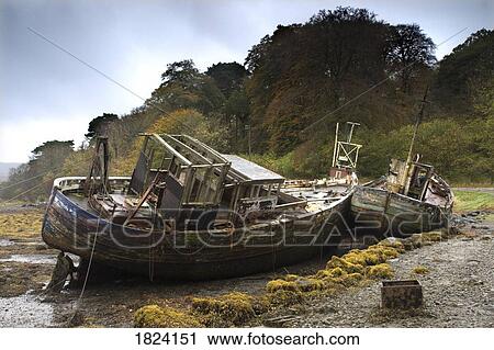Two old and abandoned boats on the shore of Isle of Mull, Scotland View Large Photo Image Stock Image - Two old and abandoned boats on the shore of Isle of Mull, Scotland. Fotosearch